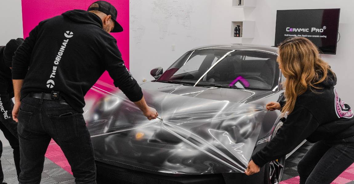 ceramic professionals applying a clear bra to car