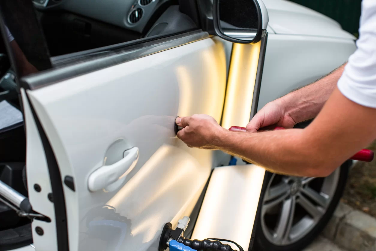 paintless dent removal on white car